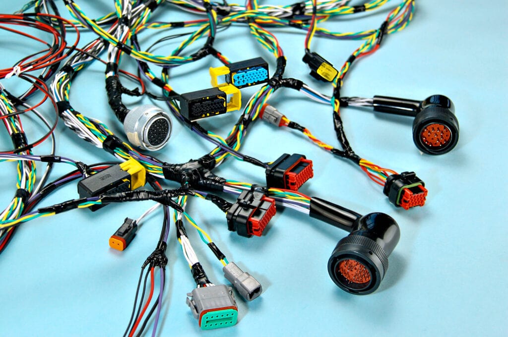 Photo of an EV wire harness, with exposed wires arranged in a neat and organized manner, showing the intricate connections and complex design.